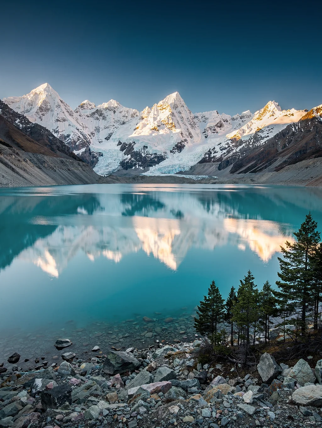 Reflective alpine lake with mountain backdrop